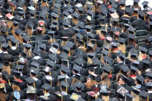 A large group of graduates wearing caps and gowns.